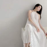 Halterneck Pleated Silk Midi Dress with Flowing A-Line Silhouette and Backless Detail